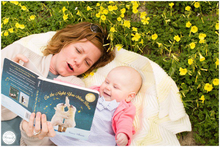Portrait photographer Lyndsay Curtis photographs six month old Madi and her mom having story time in a field of spring yellow flowers | www.lyndsaycurtis.com
