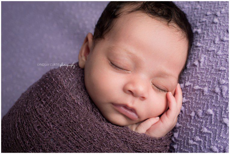 Portrait photographer Lyndsay Curtis photographs newborn girl in purple in her in-home newborn studio. | www.lyndsaycurtis.com