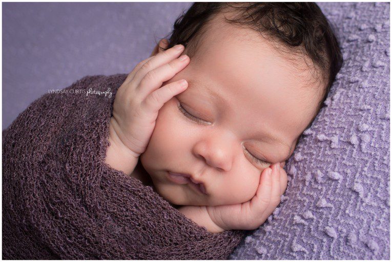 Portrait photographer Lyndsay Curtis photographs newborn girl in purple in her in-home newborn studio. | www.lyndsaycurtis.com