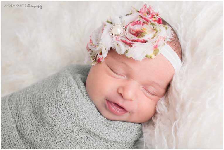 Portrait photographer Lyndsay Curtis photographs newborn girl in her in-home newborn studio. | www.lyndsaycurtis.com