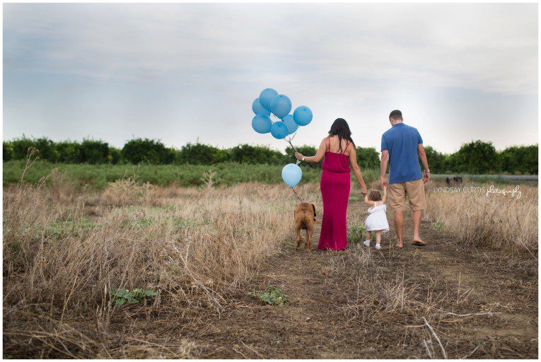 It's a boy! Portrait photographer Lyndsay Curtis photographs an outdoor gender reveal session for the pregnant Thomas family in Sigonella, Sicily. | www.lyndsaycurtis.com