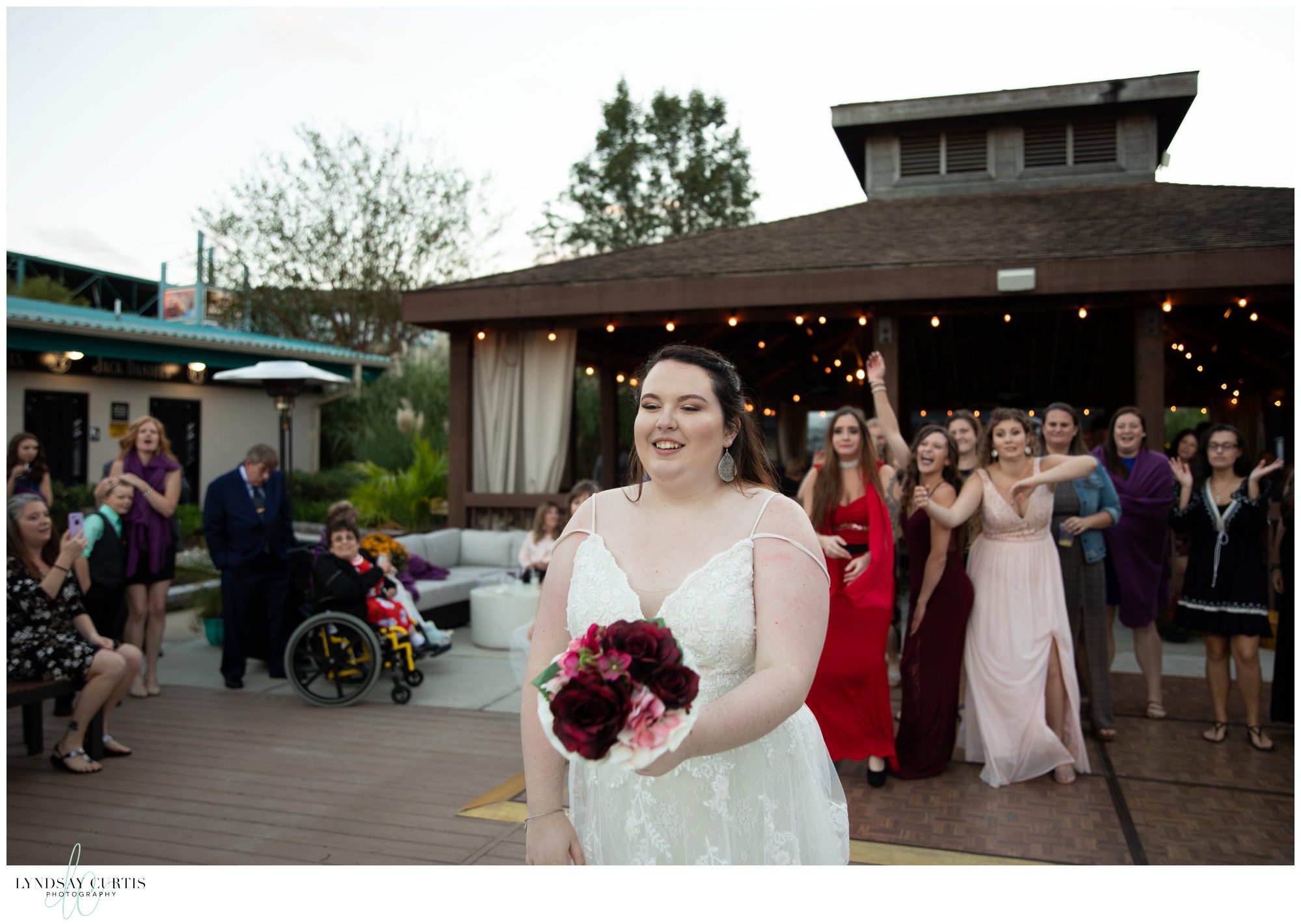 Virginia Beach wedding photographer Lyndsay Curtis Photography - Bride bouquet toss at wedding reception