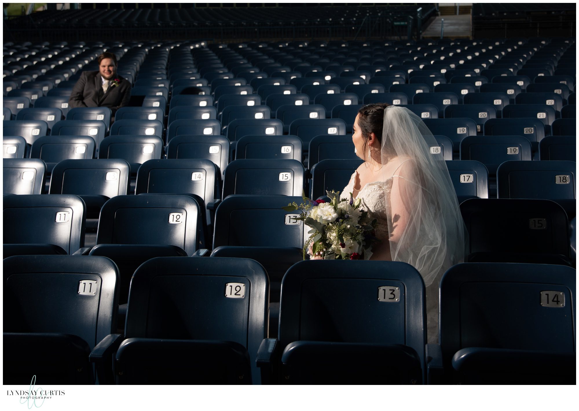 Virginia Beach wedding photographer Lyndsay Curtis Photography - Fun sports themed bride and groom portrait in bleacher seats